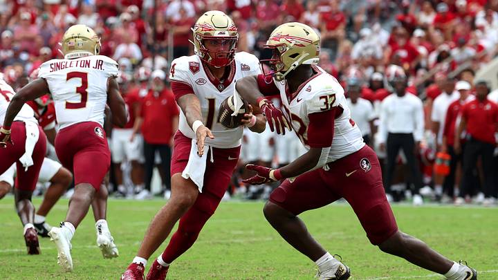 Sep 19, 2026; Tuscaloosa, Alabama, USA; Florida State Seminoles quarterback Ashton Daniels (14) fakes a handoff to Florida State Seminoles running back Ousmane Kromah (32) during the first quarter against the Alabama Crimson Tide at Saban Field at Bryant-Denny Stadium. Mandatory Credit: David Leong-Imagn Images