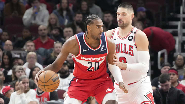Apr 11, 2025; Chicago, Illinois, USA; Chicago Bulls center Nikola Vucevic (9) defends Washington Wizards forward Alex Sarr (20) during the first quarter at United Center. Mandatory Credit: David Banks-Imagn Images
