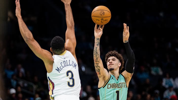 Jan 25, 2025; Charlotte, North Carolina, USA; Charlotte Hornets guard LaMelo Ball (1) shoots the ball against New Orleans Pelicans guard CJ McCollum (3) during the first quarter of at Spectrum Center. Mandatory Credit: Scott Kinser-Imagn Images