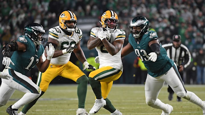 Jan 12, 2025; Philadelphia, Pennsylvania, USA; Green Bay Packers running back Josh Jacobs (8) is tackled by Philadelphia Eagles linebacker Nakobe Dean (17) and defensive tackle Milton Williams (93) in an NFC wild card game at Lincoln Financial Field. Mandatory Credit: Eric Hartline-Imagn Images Jan 12, 2025; Philadelphia, Pennsylvania, USA; Green Bay Packers running back Josh Jacobs (8) is tackled by Philadelphia Eagles linebacker Nakobe Dean (17) and defensive tackle Milton Williams (93) in an NFC wild card game at Lincoln Financial Field. Mandatory Credit: Eric Hartline-Imagn Images