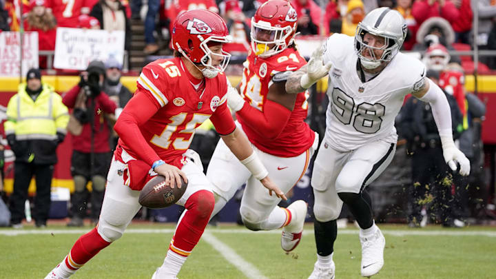 Dec 25, 2023; Kansas City, Missouri, USA; Kansas City Chiefs quarterback Patrick Mahomes (15) and Las Vegas Raiders defensive end Maxx Crosby (98) during the game at GEHA Field at Arrowhead Stadium. Mandatory Credit: Denny Medley-Imagn Images