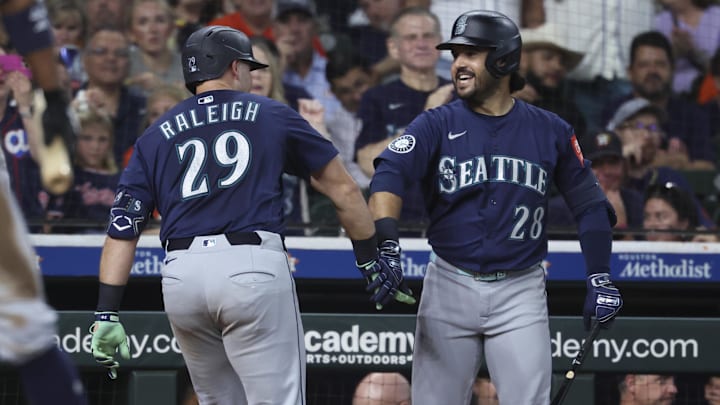 Sep 20, 2025; Houston, Texas, USA; Seattle Mariners catcher Cal Raleigh (29) celebrates with third baseman Eugenio Suarez (28) after hitting a home run during the third inning against the Houston Astros at Daikin Park. Mandatory Credit: Troy Taormina-Imagn Images