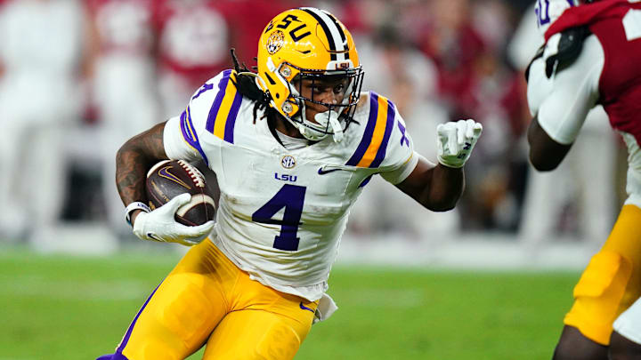 Nov 4, 2023; Tuscaloosa, Alabama, USA; LSU Tigers running back John Emery Jr. (4) carries the ball against the Alabama Crimson Tide during the second quarter at Bryant-Denny Stadium. Mandatory Credit: John David Mercer-Imagn Images