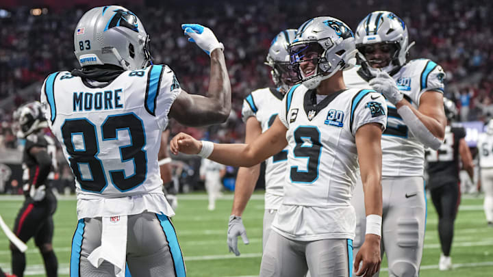 Jan 5, 2025; Atlanta, Georgia, USA; Carolina Panthers quarterback Bryce Young (9) reacts with wide receiver David Moore (83) after running for a touchdown against the Atlanta Falcons during the second half at Mercedes-Benz Stadium. Mandatory Credit: Dale Zanine-Imagn Images