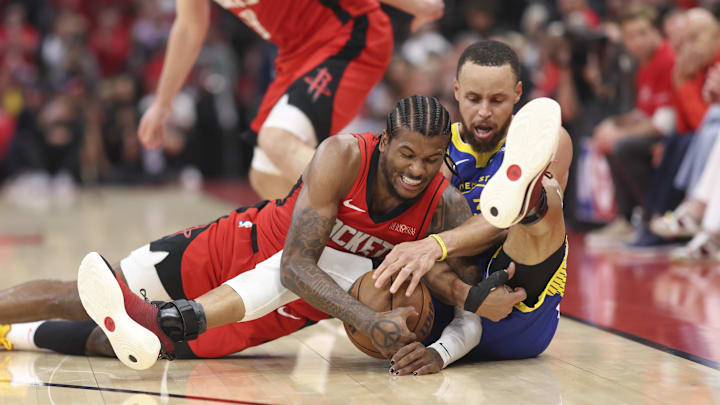 Houston Rockets guard Jalen Green (4) and Golden State Warriors guard Stephen Curry (30) battle for a loose ball in the first half during game two of the first round for the 2024 NBA Playoffs at Toyota Center.