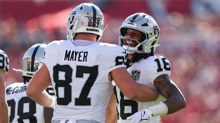 Dec 8, 2024; Tampa, Florida, USA; Las Vegas Raiders wide receiver Jakobi Meyers (16) and tight end Michael Mayer (87) celebrate after a play against the Tampa Bay Buccaneers in the first quarter at Raymond James Stadium. Mandatory Credit: Nathan Ray Seebeck-Imagn Images