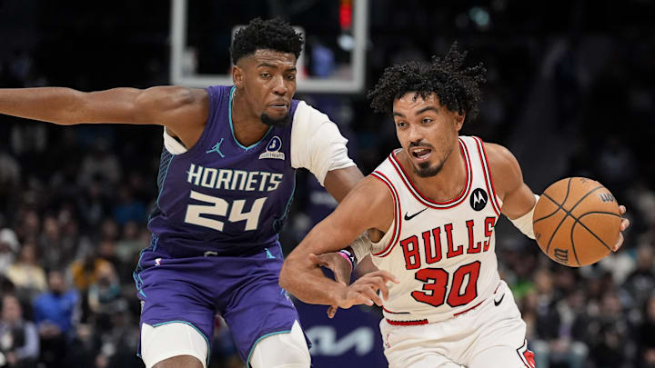 Dec 12, 2025; Charlotte, North Carolina, USA; Chicago Bulls guard Tre Jones (30) goes to the basket against Charlotte Hornets forward Brandon Miller (24) during the second half at Spectrum Center. Mandatory Credit: Jim Dedmon-Imagn Images