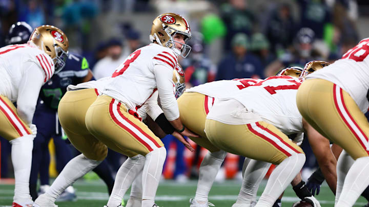 Jan 17, 2026; Seattle, WA, USA; San Francisco 49ers quarterback Brock Purdy (13) under center against the Seattle Seahawks during the first half in an NFC Divisional Round game at Lumen Field. Mandatory Credit: Kevin Ng-Imagn Images