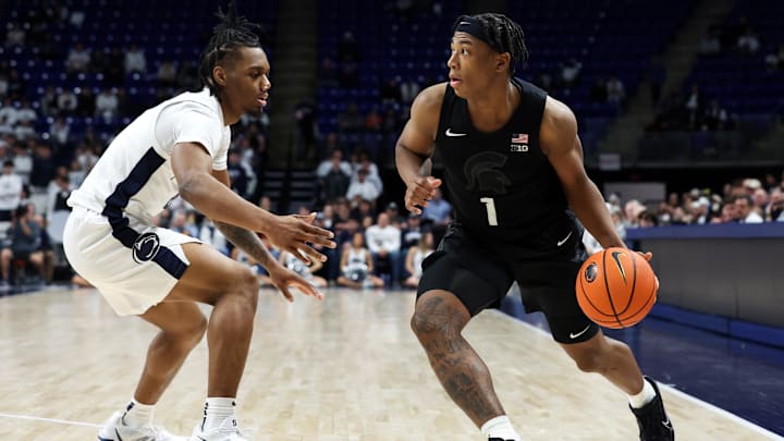 Dec 13, 2025; University Park, Pennsylvania, USA; Michigan State Spartans guard Jeremy Fears Jr (1) dribbles the ball around the outside of Penn State Nittany Lions guard Kayden Mingo (4) during the second half at Bryce Jordan Center. Mandatory Credit: Matthew O'Haren-Imagn Images Dec 13, 2025; University Park, Pennsylvania, USA; Michigan State Spartans guard Jeremy Fears Jr (1) dribbles the ball around the outside of Penn State Nittany Lions guard Kayden Mingo (4) during the second half at Bryce Jordan Center. Mandatory Credit: Matthew O'Haren-Imagn Images