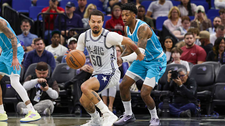Feb 12, 2025; Orlando, Florida, USA; Orlando Magic guard Cole Anthony (50) controls the ball in front of Charlotte Hornets guard Elfrid Payton (22) during the first quarter at Kia Center. Mandatory Credit: Mike Watters-Imagn Images
