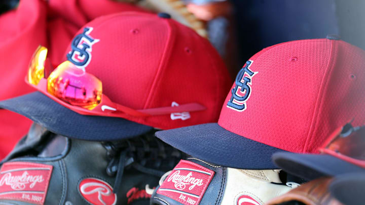 Mar 6, 2019; Tampa, FL, USA; St. Louis Cardinals hat and gloves lay in the dugout at George M. Steinbrenner Field. Mandatory Credit: Kim Klement-Imagn Images