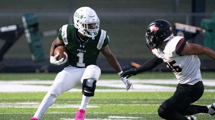 Pella's Emmanuel Diers runs the ball against North Polk's Chandler Johnson at Pella High School on Friday, Sept. 19, 2025, in Pella.