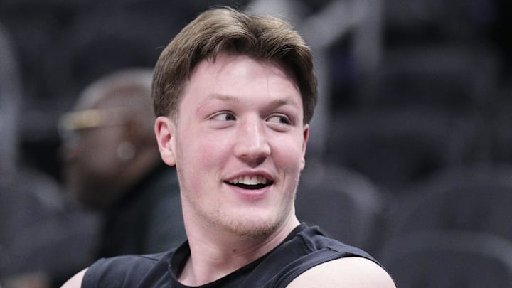 Jan 2, 2026; Milwaukee, Wisconsin, USA; Charlotte Hornets guard Kon Knueppel (7) watching his teammates warm up before a game against the Milwaukee Bucks at Fiserv Forum. Mandatory Credit: Michael McLoone-Imagn Images