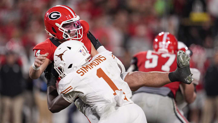 Nov 15, 2025; Athens, Georgia, USA; Texas Longhorns defensive end Colin Simmons (1) tackles Georgia Bulldogs quarterback Gunner Stockton (14) in the second half at Sanford Stadium. Mandatory Credit: Dale Zanine-Imagn Images
