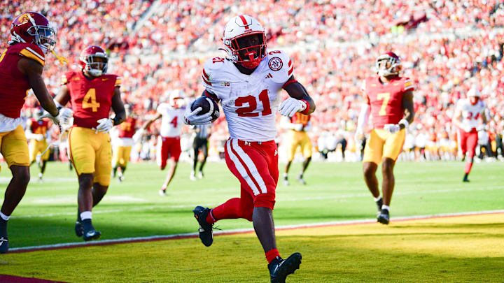 Nov 16, 2024; Los Angeles, California, USA; Nebraska Cornhuskers running back Emmett Johnson (21) scores a touchdown against the Southern California Trojans during the first half at the Los Angeles Memorial Coliseum. Nov 16, 2024; Los Angeles, California, USA; Nebraska Cornhuskers running back Emmett Johnson (21) scores a touchdown against the Southern California Trojans during the first half at the Los Angeles Memorial Coliseum.