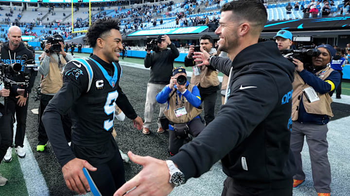 Dec 21, 2025; Charlotte, North Carolina, USA; Carolina Panthers head coach Dave Canales celebrates with quarterback Bryce Young (9) after a game against the Tampa Bay Buccaneers at Bank of America Stadium. Mandatory Credit: Bob Donnan-Imagn Images