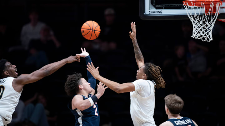 Virginia guard Chance Mallory (2) between Vanderbilt forward Tyler Harris (8) and forward AK Okereke (10) during the second half of their exhibition game at Memorial Gym in Nashville, Tenn., Thursday, Oct. 16, 2025.