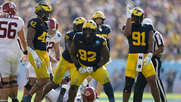 Dec 31, 2024; Tampa, FL, USA;  Alabama Crimson Tide quarterback Jalen Milroe (4) is sacked by Michigan Wolverines defensive lineman Ike Iwunnah (92) in the third quarter during the ReliaQuest Bowl at Raymond James Stadium. Mandatory Credit: Nathan Ray Seebeck-Imagn Images