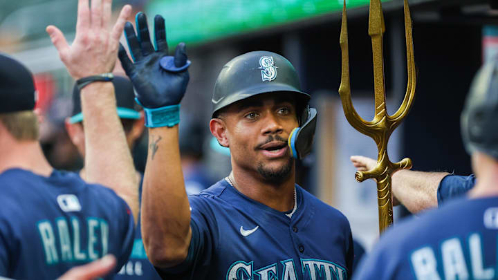 Sep 6, 2025; Cumberland, Georgia, USA; Seattle Mariners outfielder Julio Rodriguez (44) celebrates with teammates in the dugout after scoring against the Atlanta Braves during the first inning at Truist Park. Mandatory Credit: Jordan Godfree-Imagn Images