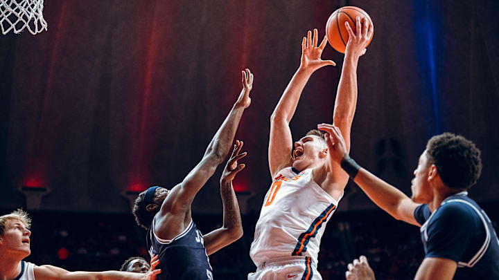 Illinois forward David Mirkovic (0) drives to the rim against two Jackson State defenders in the Illini's 113-55 win over the Tigers on Monday at the State Farm Center in Champaign, Illinois.