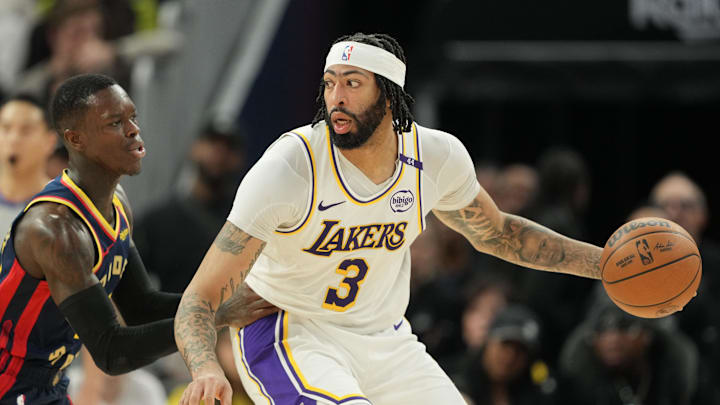 Jan 25, 2025; San Francisco, California, USA; Los Angeles Lakers forward Anthony Davis (3) dribbles against Golden State Warriors guard Dennis Schroder (left) during the fourth quarter at Chase Center. Mandatory Credit: Darren Yamashita-Imagn Images