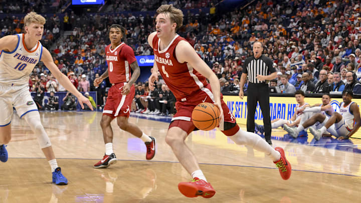Mar 15, 2025; Nashville, TN, USA;  Alabama Crimson Tide forward Grant Nelson (4) drives to the basket against the Florida Gators during the first half at Bridgestone Arena. Mandatory Credit: Steve Roberts-Imagn Images