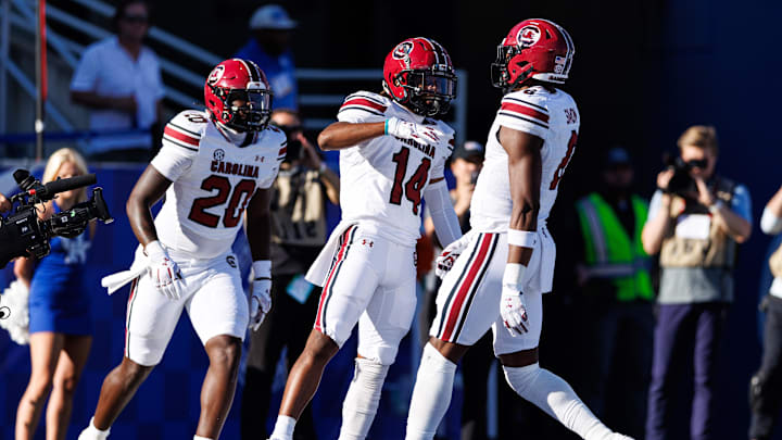 South Carolina football TE Michael Smith (20) and WR Jared Brown (14) celebrating a touchdown with TE Josh Simon (6)