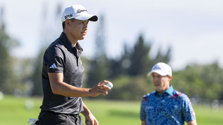 January 8, 2023; Maui, Hawaii, USA; Collin Morikawa (left) acknowledges the crowd after making his