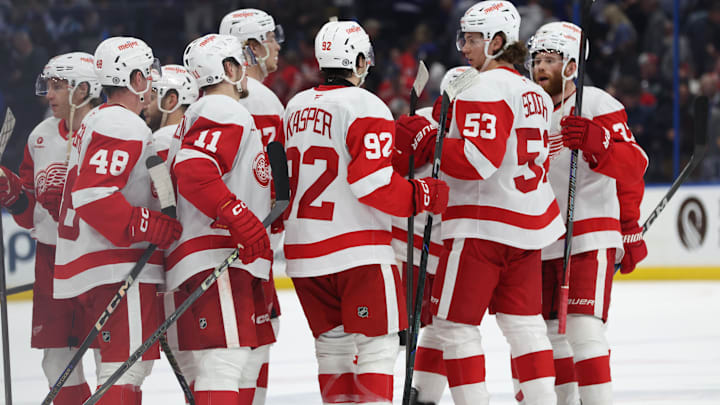 Apr 11, 2025; Tampa, Florida, USA; Detroit Red Wings right wing Vladimir Tarasenko (11), center Marco Kasper (92), defenseman Moritz Seider (53) and teammates celebrate after they beat the Tampa Bay Lightning at Amalie Arena. Mandatory Credit: Kim Klement Neitzel-Imagn Images