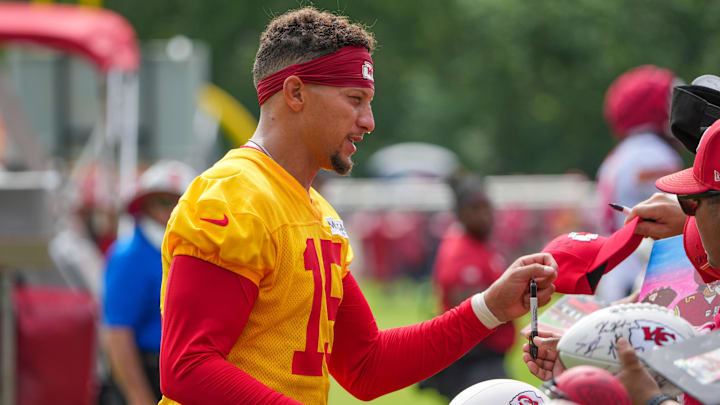 Jul 22, 2025; St. Joseph, MO, USA; Kansas City Chiefs quarterback Patrick Mahomes (15) signs autographs for fans after training camp at Missouri Western State University. Mandatory Credit: Denny Medley-Imagn Images
