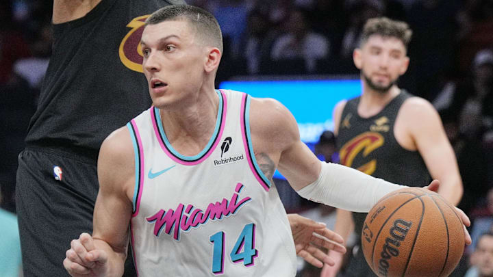 Jan 29, 2025; Miami, Florida, USA;  Miami Heat guard Tyler Herro (14) looks to pass the ball as Cleveland Cavaliers guard Caris LeVert (3) defends during the second half at Kaseya Center. Mandatory Credit: Jim Rassol-Imagn Images