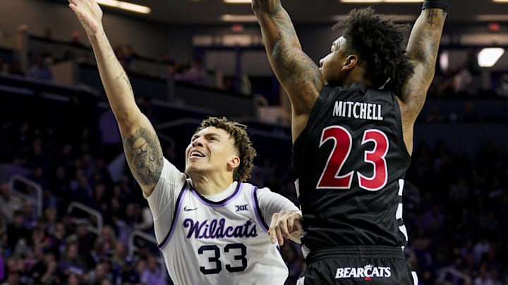 Dec 30, 2024; Manhattan, Kansas, USA; Kansas State Wildcats guard Coleman Hawkins (33) shoots against Cincinnati Bearcats forward Dillon Mitchell (23) during the second half at Bramlage Coliseum. Mandatory Credit: Jay Biggerstaff-Imagn Images Dec 30, 2024; Manhattan, Kansas, USA; Kansas State Wildcats guard Coleman Hawkins (33) shoots against Cincinnati Bearcats forward Dillon Mitchell (23) during the second half at Bramlage Coliseum. Mandatory Credit: Jay Biggerstaff-Imagn Images
