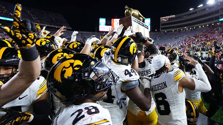 Oct 11, 2025; Madison, Wisconsin, USA; The Iowa Hawkeyes celebrate a win with The Heartland Trophy after the game against the Wisconsin Badgers at Camp Randall Stadium. Mandatory Credit: Ross Harried-Imagn Images Oct 11, 2025; Madison, Wisconsin, USA; The Iowa Hawkeyes celebrate a win with The Heartland Trophy after the game against the Wisconsin Badgers at Camp Randall Stadium. Mandatory Credit: Ross Harried-Imagn Images