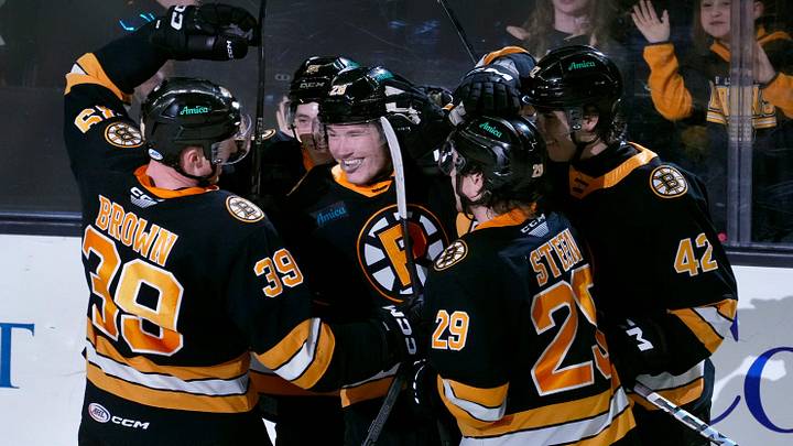 The celebrate Providence Bruins a second period score by teammate Providence forward Jimmy Lambert.