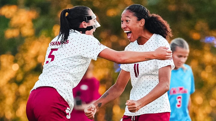 Arkansas soccer players celebrate a goal against Ole Miss.