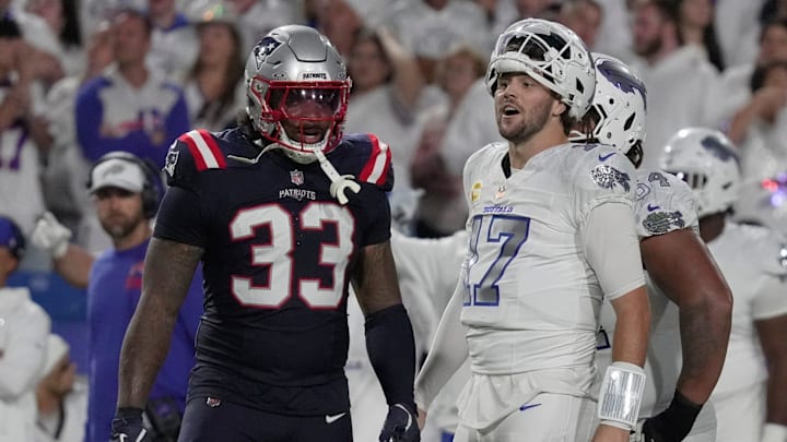 Buffalo Bills quarterback Josh Allen reacts to a play during second half action at at Highmark Stadium in Orchard Park on Oct. 5, 2025. Besides him, New England Patriots linebacker Anfernee Jennings watches.