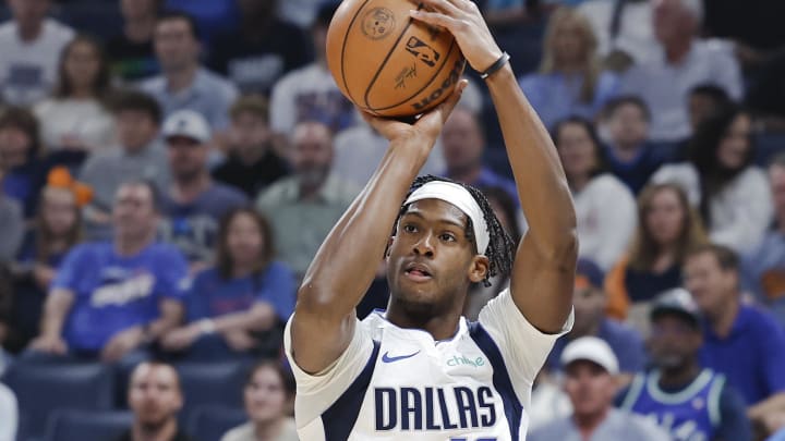 Apr 14, 2024; Oklahoma City, Oklahoma, USA; Dallas Mavericks forward Olivier-Maxence Prosper (18) shoots a three-point basket against the Oklahoma City Thunder during the first quarter at Paycom Center. Mandatory Credit: Alonzo Adams-USA TODAY Sports