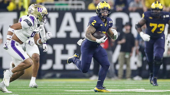 Michigan running back Blake Corum runs against Washington during the first half of the national