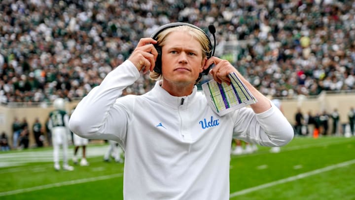 UCLA's assistant head coach Jerry Neuheisel adjusts his headset during the third quarter in the game against Michigan State on Saturday, Oct. 11, 2025, at Spartan Stadium in East Lansing.