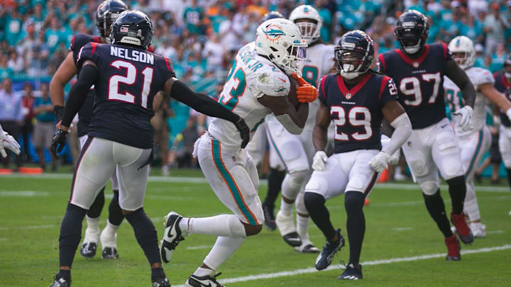 Miami Dolphins running back Jeff Wilson Jr. (23) runs into the end zone to score the Dolphins' first touchdown in the first quarter of the game between host Miami Dolphins and the Houston Texans at Hard Rock Stadium on Sunday, November 27, 2022, in Miami Gardens, FL.