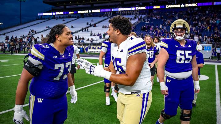 Champ Taulealea and Kodi Greene have a running debate at the Spring Game. 