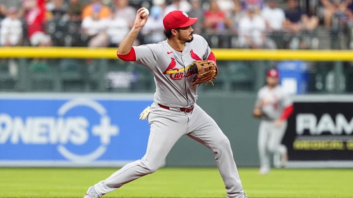 Jul 22, 2025; Denver, Colorado, USA; St. Louis Cardinals third baseman Nolan Arenado (28) fields the ball in the first inning against the Colorado Rockies at Coors Field. Mandatory Credit: Ron Chenoy-Imagn Images