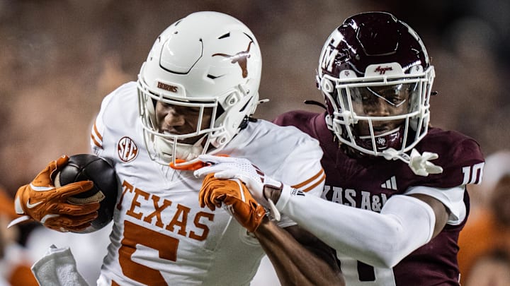 Nov 30, 2024; College Station, Texas, USA; Texas Longhorns wide receiver Ryan Wingo (5) carries the ball against Texas A&M Aggies defensive back Dezz Ricks (10) in the second quarter of the Lone Star Showdown game at Kyle Field. Mandatory Credit: Sara Diggins/USA TODAY Network via Imagn Images