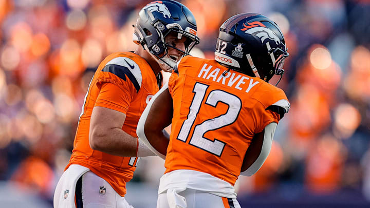Oct 19, 2025; Denver, Colorado, USA; Denver Broncos quarterback Bo Nix (10) celebrates the touchdown of running back RJ Harvey (12) in the fourth quarter against the New York Giants at Empower Field at Mile High. Mandatory Credit: Isaiah J. Downing-Imagn Images