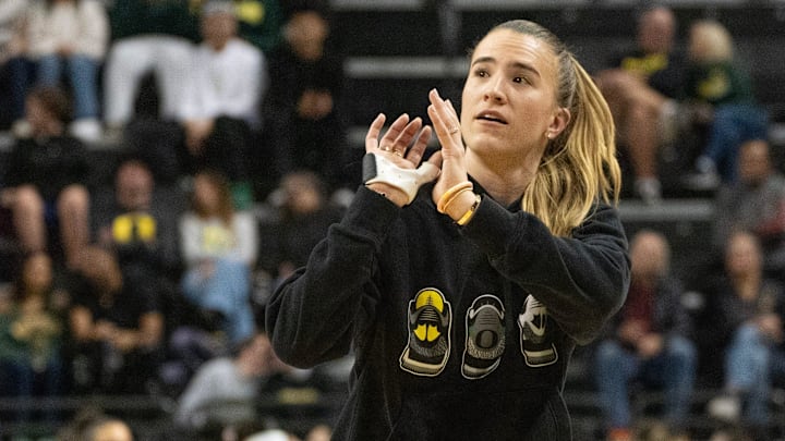 Sabrina Ionescu mimes taking a shot during her appearance on the court during the game between Oregon and Baylor at Matthew Knight Arena in Eugene.