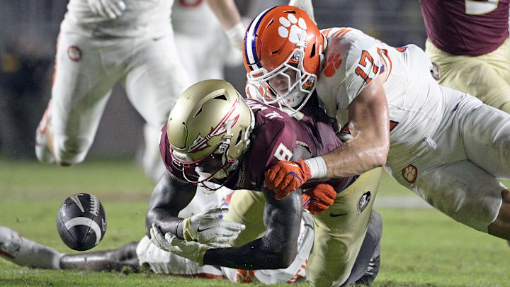 Oct 5, 2024; Tallahassee, Florida, USA; Clemson Tigers linebacker Wade Woodaz (17) forces a fumble by Florida State Seminoles wide receiver Hykeem Williams (8) during the second half at Doak S. Campbell Stadium. 
