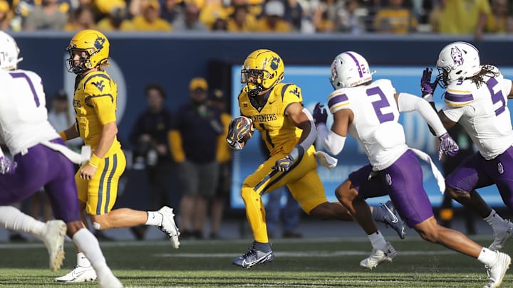 Sep 7, 2024; Morgantown, West Virginia, USA; West Virginia Mountaineers running back Jahiem White (1) runs the ball during the first quarter against the Albany Great Danes at Mountaineer Field at Milan Puskar Stadium. Mandatory Credit: Ben Queen-Imagn Images