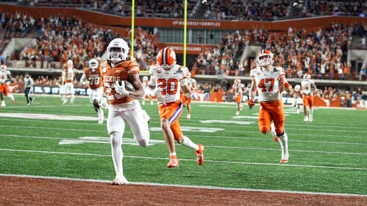 Texas Longhorns running back Jaydon Blue (23) runs into the endzone for a touchdown against Clemson Tigers cornerback Avieon Terrell (20) and Clemson Tigers linebacker Sammy Brown (47) in the second half of an NCAA College Football Playoffs first round game at Darrell K Royal Texas Memorial Stadium, Austin, Texas, Saturday, Dec. 21, 2024.