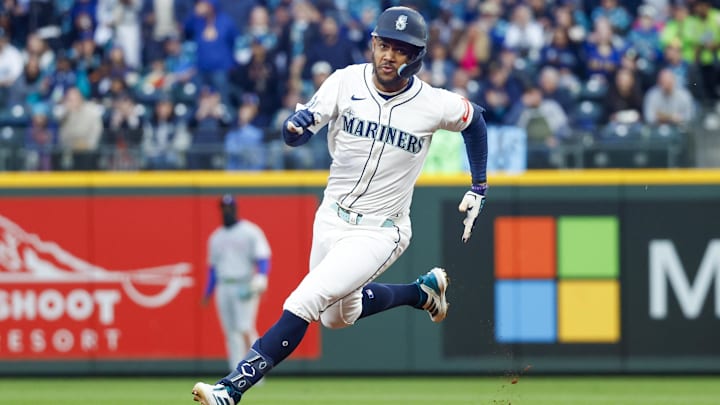 Seattle Mariners center fielder Julio Rodríguez goes to third base after an RBI triple against the Texas Rangers on April 12 at T-Mobile Park.