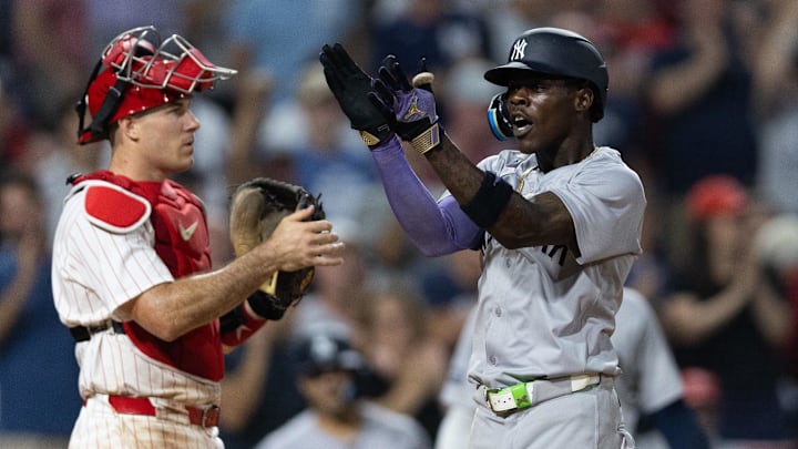 New York Yankees third base Jazz Chisholm Jr. reacts in front of Philadelphia Phillies catcher J.T. Realmuto after hitting a home run